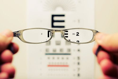 vision impaired human looking at big letters and small letters